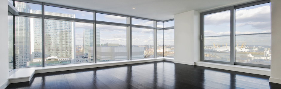 empty apartment with hard wood floor an floor to ceiling windows