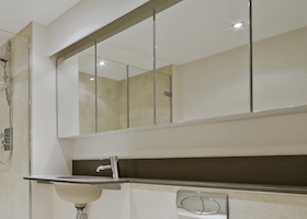 luxury modern en-suite bathroom with floor to ceiling marble tiles